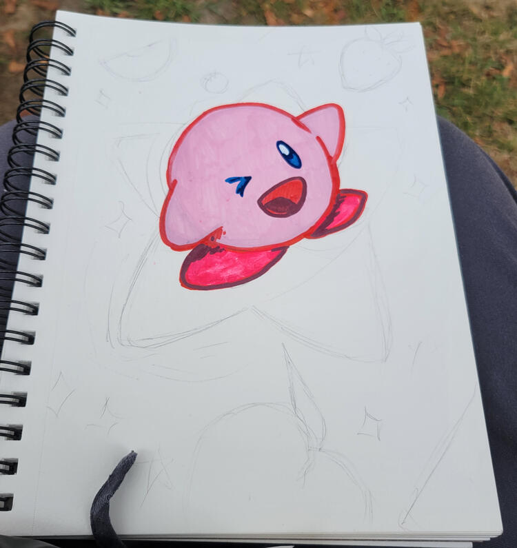 an unfinished kirby in my lap at the chalk festival!