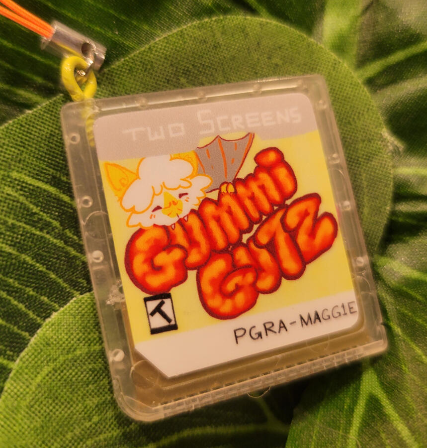 Front of the shaker chip phone charm. casing and sticker modeled and sized in-house, outsourced for printing, returned to house for assembly.